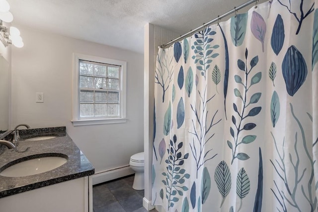 bathroom featuring a baseboard heating unit, a sink, toilet, and double vanity