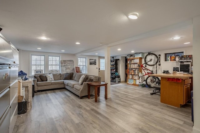 living room with light wood-style floors, plenty of natural light, and recessed lighting