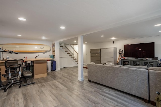 living room featuring light wood-type flooring, stairway, and recessed lighting