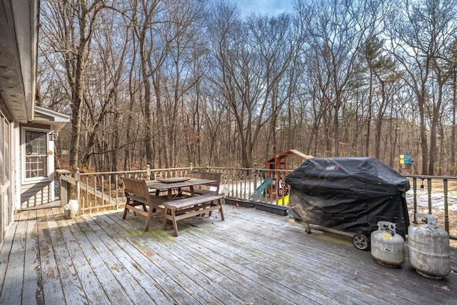 deck featuring outdoor dining space and area for grilling