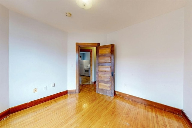 76 Belden St, Boston, MA 02125 - spare room with baseboards, a smoke detector, and light wood finished floors