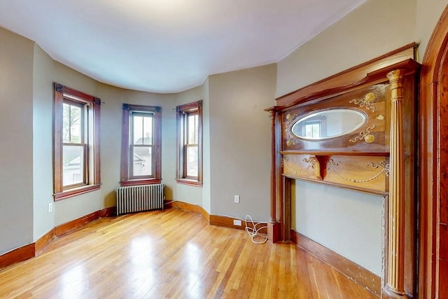 76 Belden St, Boston, MA 02125 - spare room with radiator heating unit, wood finished floors, and baseboards
