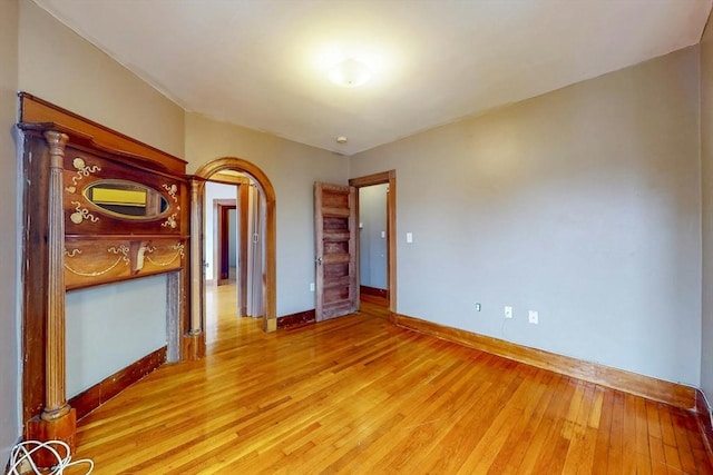 76 Belden St, Boston, MA 02125 - empty room with light wood-style flooring and baseboards