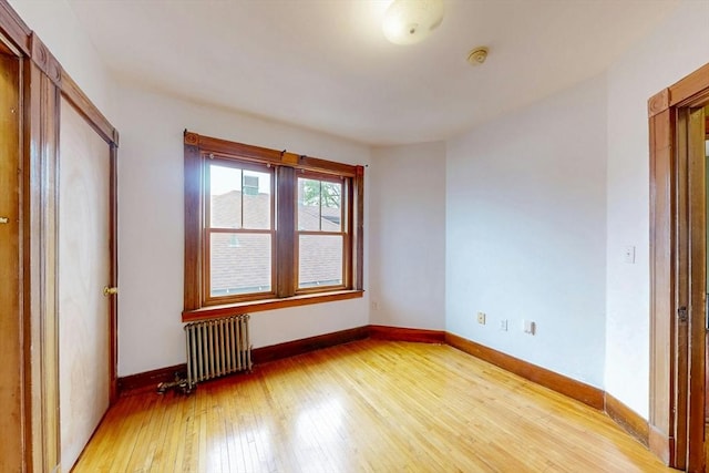 76 Belden St, Boston, MA 02125 - unfurnished bedroom with radiator, light wood-style flooring, and baseboards