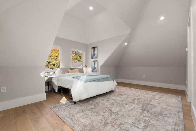 bedroom featuring wood-type flooring and lofted ceiling