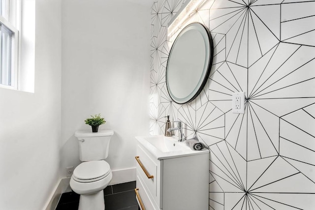 bathroom with tile patterned flooring, vanity, and toilet