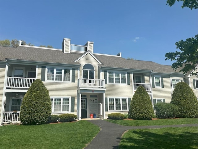 view of front of home featuring a front yard and a chimney