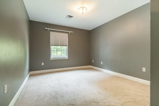 spare room with carpet and baseboards