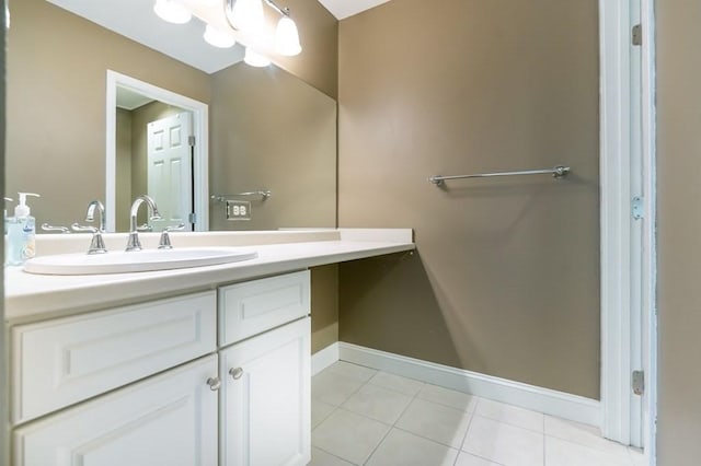 bathroom featuring tile patterned floors, baseboards, and vanity