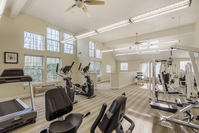 exercise room featuring ceiling fan, baseboards, carpet flooring, beam ceiling, and a high ceiling