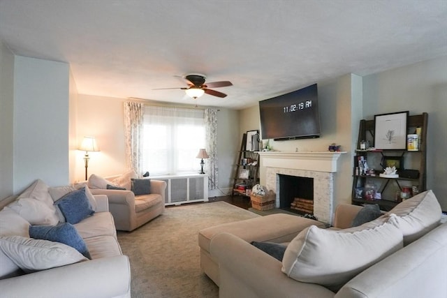 1013 Pleasant St, Worcester, MA 01602 - living room featuring ceiling fan, a fireplace with flush hearth, and radiator
