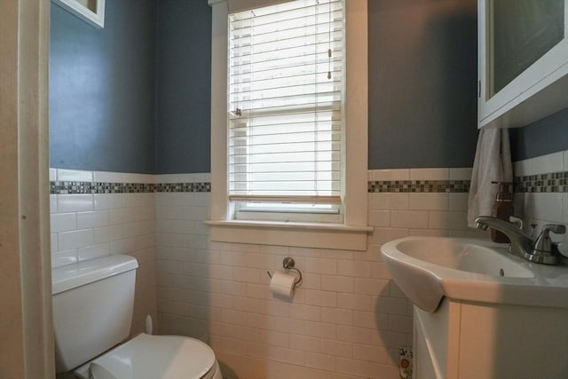1013 Pleasant St, Worcester, MA 01602 - bathroom featuring tile walls, toilet, wainscoting, vanity, and healthy amount of natural light