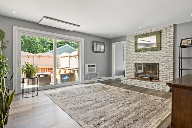 living room with a fireplace, recessed lighting, wood finished floors, and baseboard heating