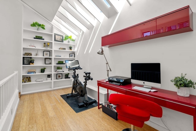 office area featuring hardwood / wood-style flooring and lofted ceiling with skylight