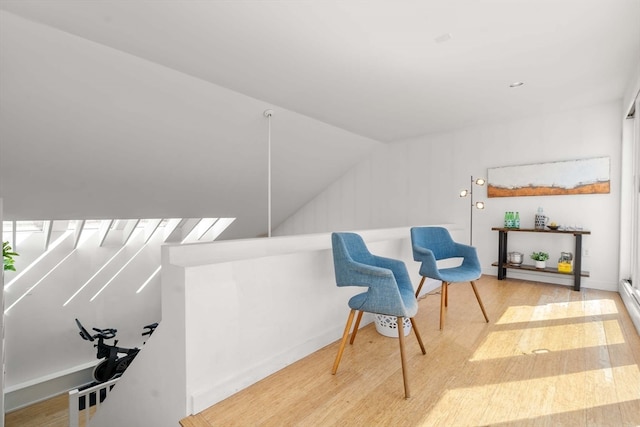 sitting room featuring light hardwood / wood-style flooring and vaulted ceiling