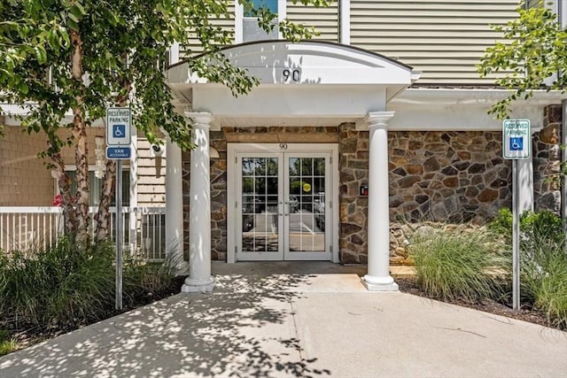 90 Trotter Rd Unit 309, Weymouth, MA 02190 - property entrance with french doors and stone siding