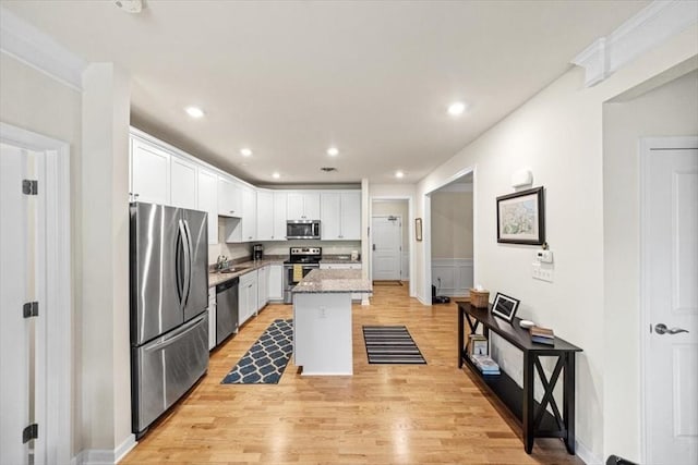 90 Trotter Rd Unit 309, Weymouth, MA 02190 - kitchen with stainless steel appliances, white cabinetry, light wood-style floors, a center island, and recessed lighting