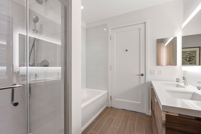 bathroom featuring vanity and shower with separate bathtub