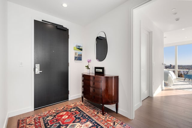 hallway with light hardwood / wood-style floors