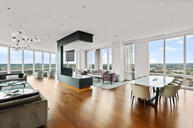 interior space with light hardwood / wood-style floors, a chandelier, and floor to ceiling windows