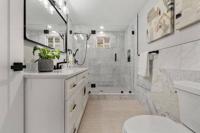 bathroom featuring plenty of natural light, vanity, and tile walls