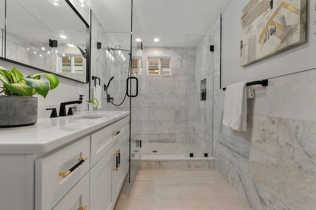 bathroom featuring vanity, tile patterned floors, and a shower with shower door