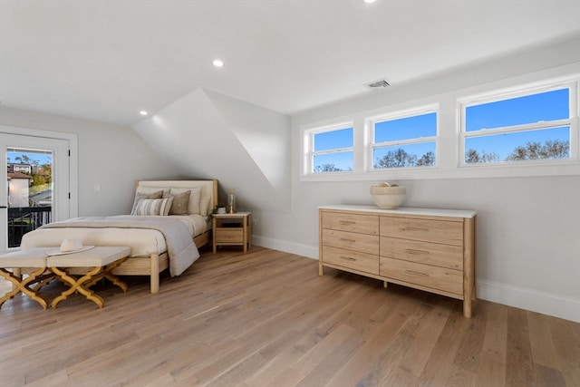 bedroom featuring access to outside, light hardwood / wood-style flooring, and lofted ceiling