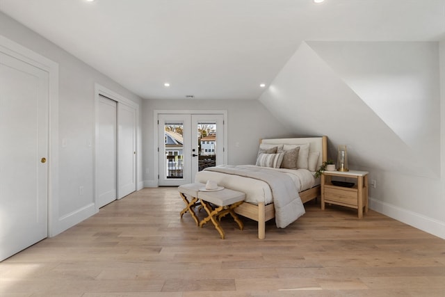 bedroom with access to outside, vaulted ceiling, and light hardwood / wood-style floors