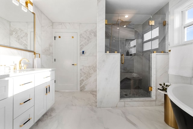 bathroom featuring plus walk in shower, vanity, and tile walls