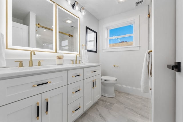 bathroom with vanity, toilet, and walk in shower