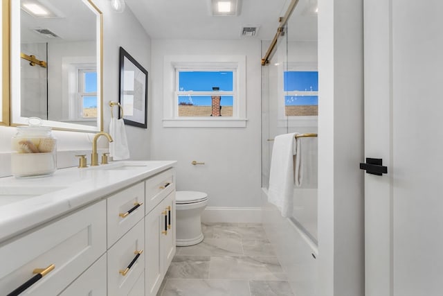 full bathroom with vanity, toilet, and bath / shower combo with glass door