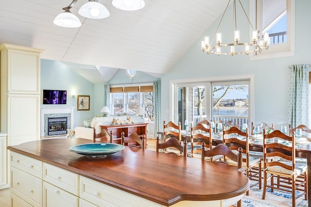 dining space with vaulted ceiling and a chandelier