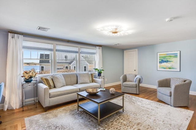 living room with hardwood / wood-style flooring and a healthy amount of sunlight