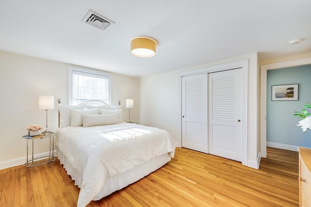 bedroom with light hardwood / wood-style flooring and a closet