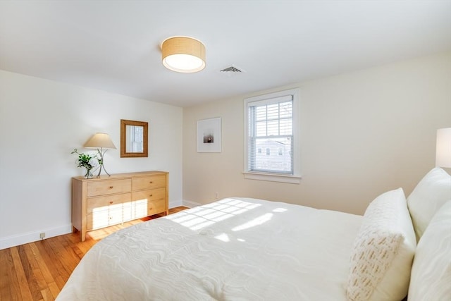 bedroom with hardwood / wood-style flooring