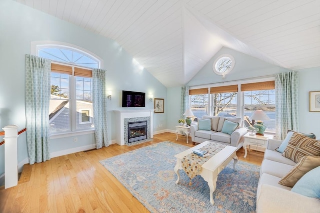 living room featuring vaulted ceiling, a wealth of natural light, and hardwood / wood-style floors