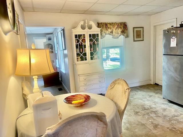 dining space with a paneled ceiling