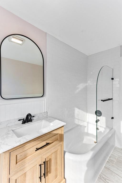 bathroom with shower / bathing tub combination and vanity