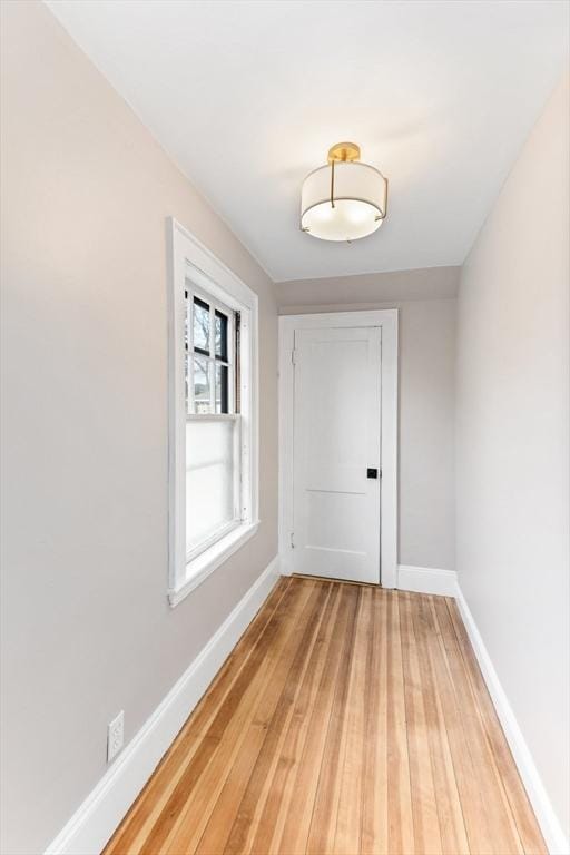 unfurnished room featuring light wood-style flooring and baseboards