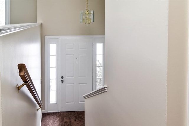 carpeted entryway with a wealth of natural light