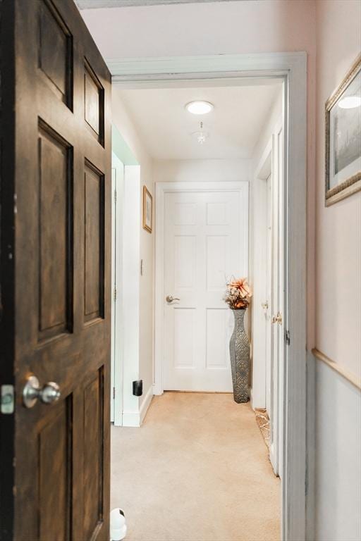 hallway featuring light carpet