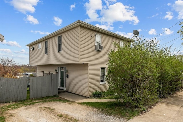 back of property with fence and cooling unit