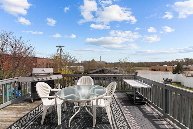wooden deck with area for grilling and outdoor dining area