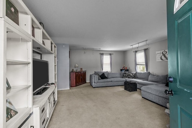 living room featuring light colored carpet and track lighting