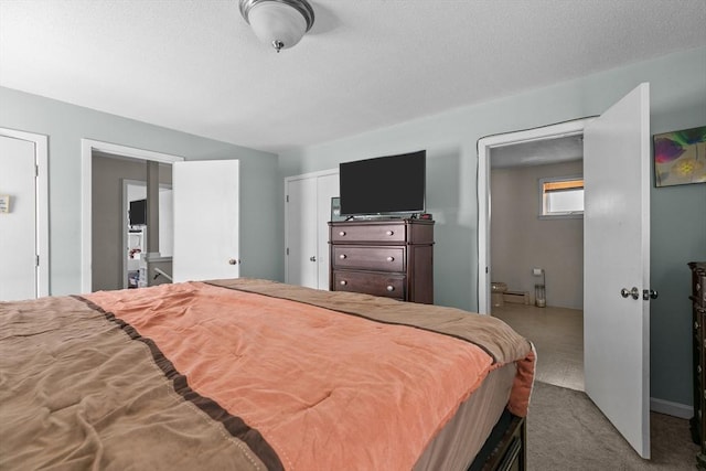 carpeted bedroom featuring a textured ceiling