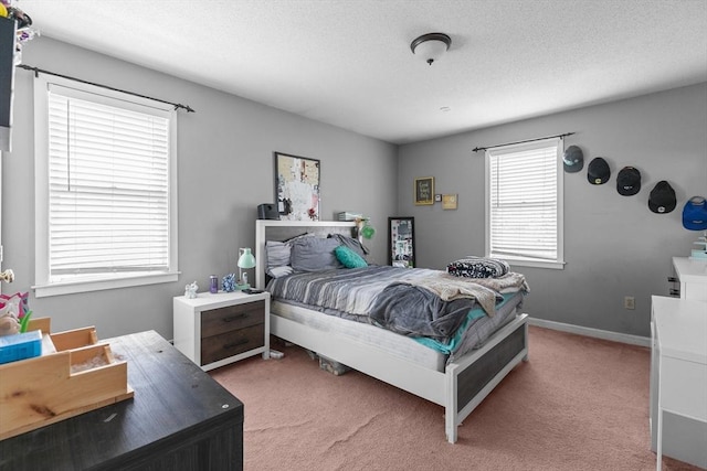 bedroom with light carpet and baseboards