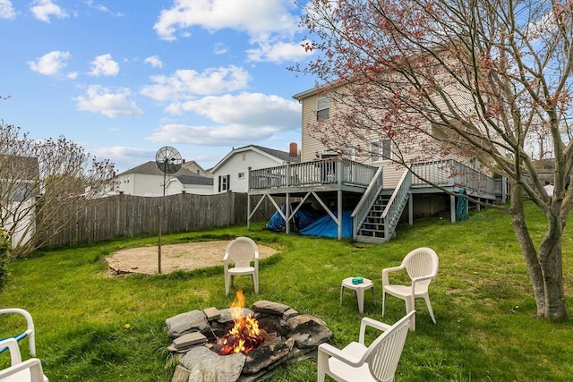 view of yard with an outdoor fire pit, a deck, and stairway