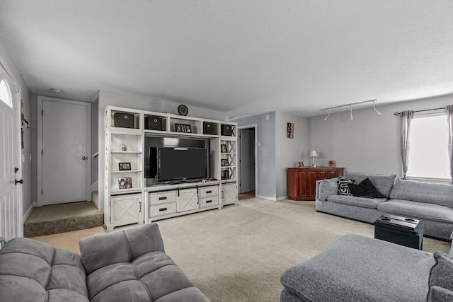 living area with light carpet and baseboards