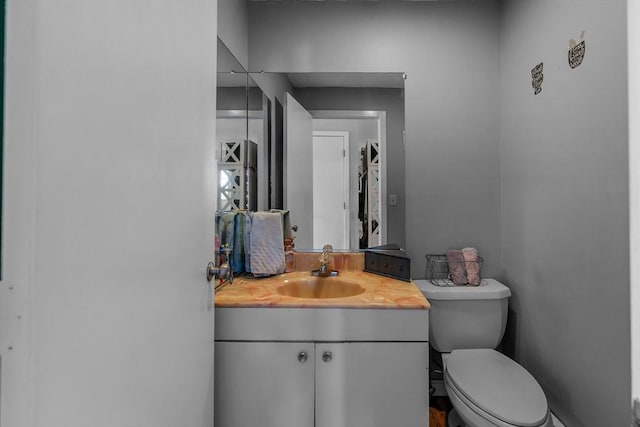 bathroom with toilet and vanity
