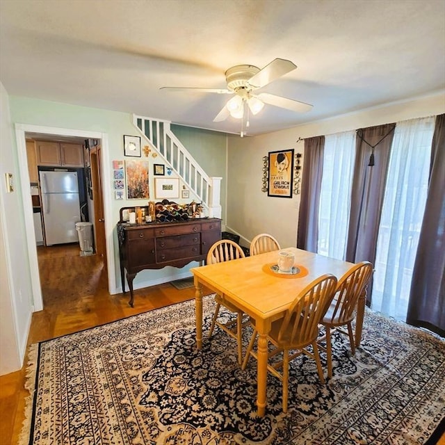 129 Lafayette St, Lowell, MA 01854 - dining room with a ceiling fan, wood finished floors, and stairway